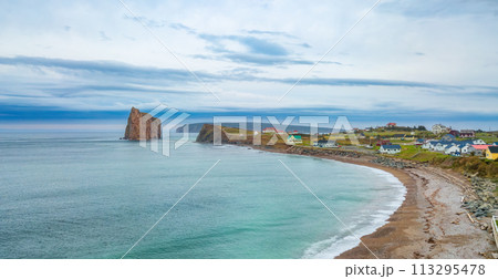 Town on the Atlantic Ocean Coast during a cloudy sunset. Perce, Quebec, Canada. Town on the Atlantic Ocean Coast during a cloudy sunset. Perce, Quebec, Canada. 113295478
