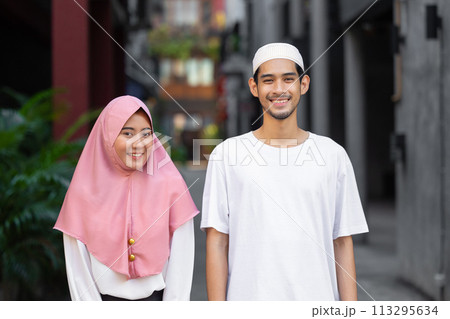 portrait happy muslim teen man and women couple lover friend standing together enjoy fun lifestyle outdoors portrait happy muslim teen man and women couple lover friend standing together enjoy fun lifestyle outdoors 113295634