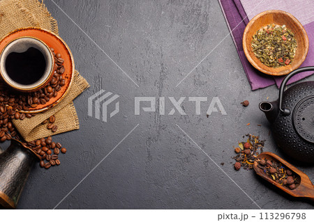A tantalizing display of roasted coffee beans and dry tea leaves, accompanied by an espresso coffee cup and a teapot A tantalizing display of roasted coffee beans and dry tea leaves, accompanied by an espresso coffee cup and a teapot 113296798