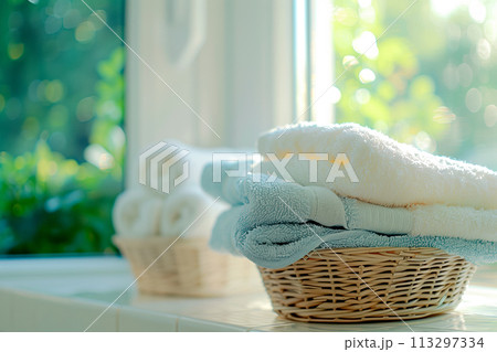 Stack of clean towels in laundry wicker basket bathroom. The towels showcasing their soft and fluffy after laundry 113297334