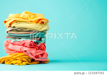 Pile of knitted sweaters and cozy scarves on solid background with copy space, Stack of clothes Pile of knitted sweaters and cozy scarves on solid background with copy space, Stack of clothes 113297341