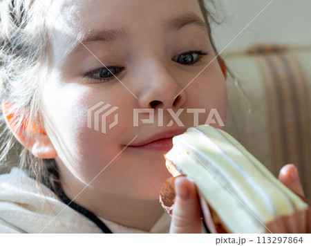 A little girl looks at a cake and wants to eat it. High quality photo A little girl looks at a cake and wants to eat it. High quality photo 113297864