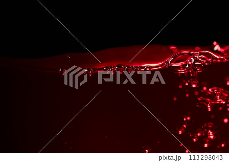 Red wine on a black background, abstract splashing. 113298043