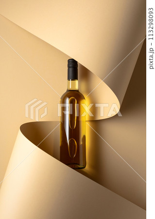 Bottle of white wine on a beige background. Bottle of white wine on a beige background. 113298093