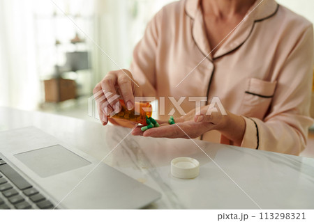 Sick woman taking painkillers daily 113298321