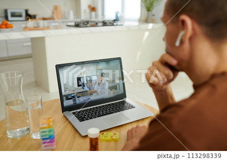Man video calling doctor to discuss results of chest xray 113298339