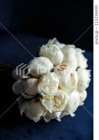 Bride's bouquet of white peonies with wedding rings Bride's bouquet of white peonies with wedding rings 113298495