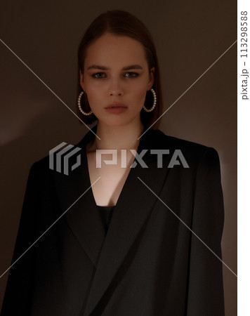 Fashionable girl model on dark grey background in Fashionable girl model on dark grey background in 113298588