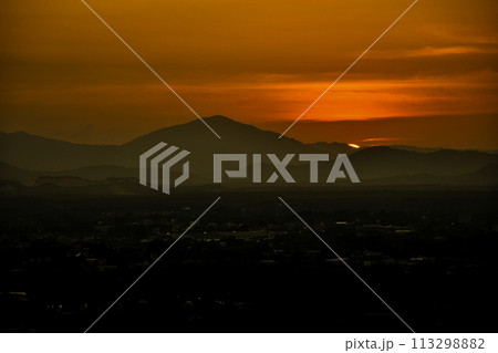 Night natural scene, Good night The golden light from the setting sun, there is still a beautiful golden light and mountains in the shadows. The light from light bulbs in homes becomes more prominent 113298882