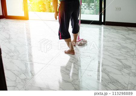 Women are mopping down the hallway to clean and rid themselves of the coronavirus disease, or COVID-19, during the holidays. Take a Close up photo Women are mopping down the hallway to clean and rid themselves of the coronavirus disease, or COVID-19, during the holidays. Take a Close up photo 113298889