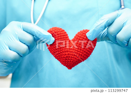 Asian woman doctor holding red heart for health in hospital. 113299747