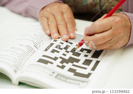 elderly woman playing sudoku puzzle game for treatment dementia prevention and Alzheimer disease. elderly woman playing sudoku puzzle game for treatment dementia prevention and Alzheimer disease. 113299882