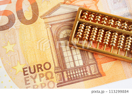 Gold abacus on banknote money, finance trading investment business currency concept. Gold abacus on banknote money, finance trading investment business currency concept. 113299884
