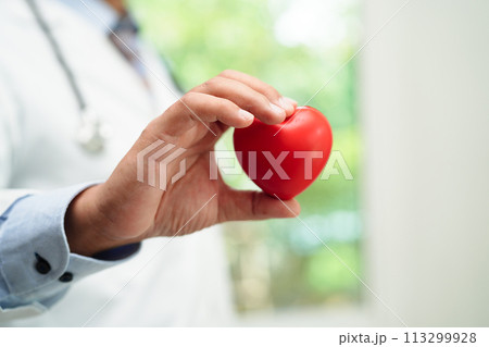 Asian woman doctor holding red heart for health in hospital. Asian woman doctor holding red heart for health in hospital. 113299928
