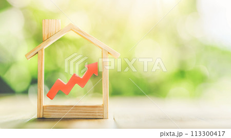 Wooden model house and red arrow up. The concept of increasing the cost of housing. High demand for real estate. The growth of rent and mortgage rates. Sale of apartments. 113300417