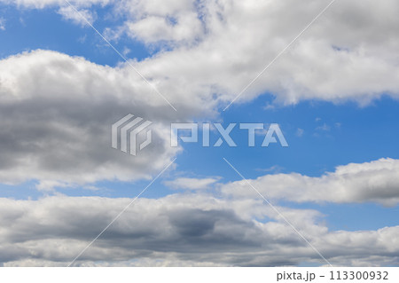 Sky unfolds in light blue, adorned with cumulus clouds for ideal backgrounds Sky unfolds in light blue, adorned with cumulus clouds for ideal backgrounds 113300932
