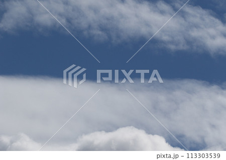 Cloudscape scenery, overcast weather above dark blue sky. Storm clouds floating in a rainy dull day with natural light. White and grey scenic environment background. Nature view. Cloudscape scenery, overcast weather above dark blue sky. Storm clouds floating in a rainy dull day with natural light. White and grey scenic environment background. Nature view. 113303539