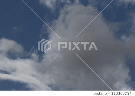 Cloudscape scenery, overcast weather above dark blue sky. Storm clouds floating in a rainy dull day with natural light. White and grey scenic environment background. Nature view. 113303754