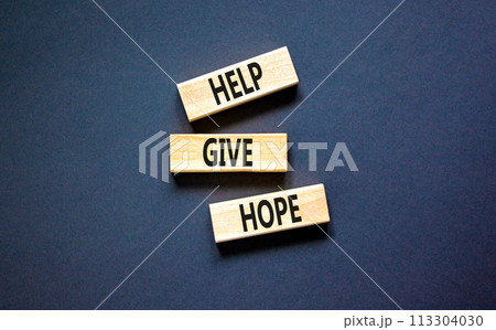 Help give hope symbol. Concept word Help give hope on beautiful wooden block. Beautiful black table black background. Business motivational help give hope concept. Copy space. Help give hope symbol. Concept word Help give hope on beautiful wooden block. Beautiful black table black background. Business motivational help give hope concept. Copy space. 113304030