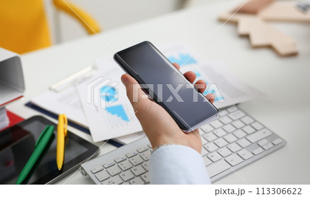 A businessman holds a new smartphone in A businessman holds a new smartphone in 113306622