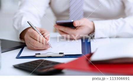 Male arm in suit and tie hold silver pen 113306691