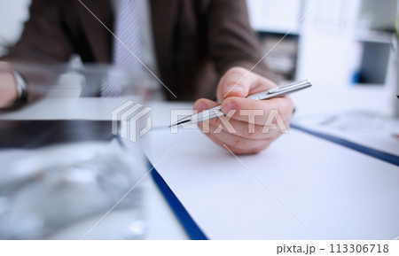 Male arm in suit and tie hold silver pen 113306718