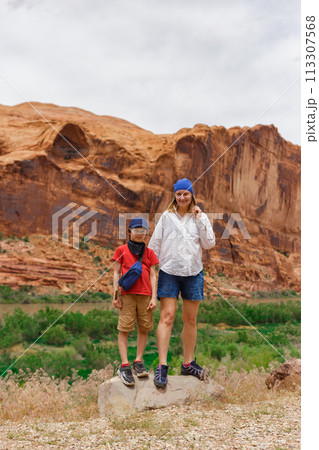 Mom and Son Standing among Rock Formations in Utah 113307568
