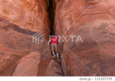 Boy Climbing Rocks in Arches National Park, Utah Boy Climbing Rocks in Arches National Park, Utah 113307570