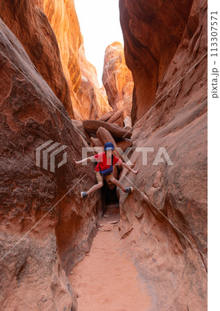 Boy Climbing Rocks in Arches National Park, Utah Boy Climbing Rocks in Arches National Park, Utah 113307571