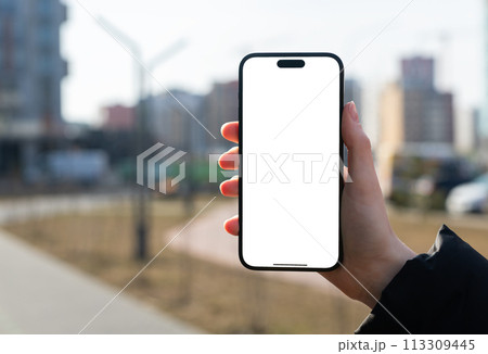 Berlin Germany January 21 2024 Hand holding mobile phone, iphone screen mockup, city background Berlin Germany January 21 2024 Hand holding mobile phone, iphone screen mockup, city background 113309445