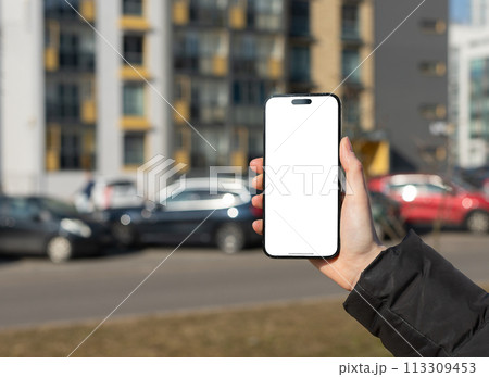 Berlin Germany January 21 2024 Hand holds mobile phone screen mockup, empty blank iphone smartphone 113309453