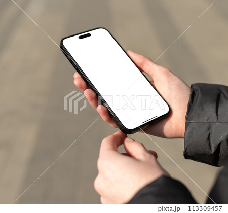 Berlin Germany January 21 2024 Hand holding, using mobile phone screen mockup, smartphone Berlin Germany January 21 2024 Hand holding, using mobile phone screen mockup, smartphone 113309457