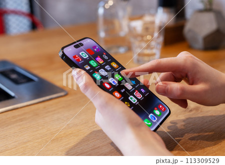 Berlin Germany January 21 2024 Hand using mobile phone, iphone smartphone, screen with app icons Berlin Germany January 21 2024 Hand using mobile phone, iphone smartphone, screen with app icons 113309529