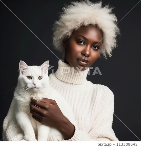 African woman in a white wig and sweater is holding white cat in her arms. Cat appears calm and content, nestled against the womans chest.  113309645