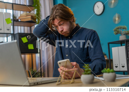 Business man using smartphone bad news lottery game results fortune loss fail at home office 113310714