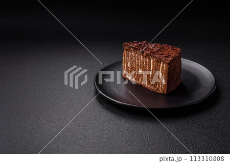 Delicious fresh cheesecake cake or snickers with cream and nuts on a ceramic plate 113310808