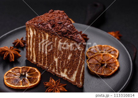 Delicious fresh cheesecake cake or snickers with cream and nuts on a ceramic plate Delicious fresh cheesecake cake or snickers with cream and nuts on a ceramic plate 113310814