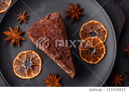 Delicious fresh cheesecake cake or snickers with cream and nuts on a ceramic plate 113310815