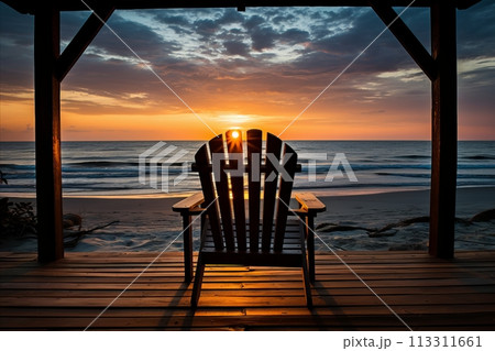sunset with a single beach chair in a bungalow veranda, the serene ocean beach 113311661