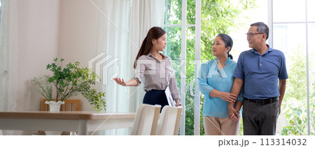 Happy couple elderly looking new home while agent real estate explaining and visit. Happy couple elderly looking new home while agent real estate explaining and visit. 113314032