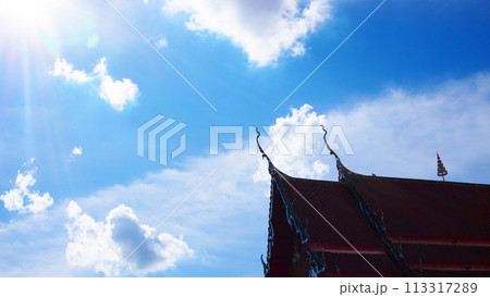 Blue sky and white clouds with sun beam over the buddhist temple roof in Thailand. Picture for use in Background image or copy space Blue sky and white clouds with sun beam over the buddhist temple roof in Thailand. Picture for use in Background image or copy space 113317289