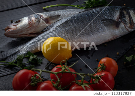 Sea bream or dorado sea fish herbs on dark slate background Top view Sea bream or dorado sea fish herbs on dark slate background Top view 113317927