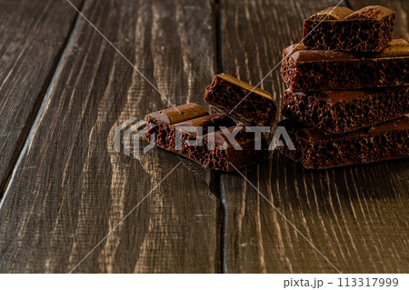 Chocolate bar pieces. Background with chocolate. Sweet food photo concept. 113317999