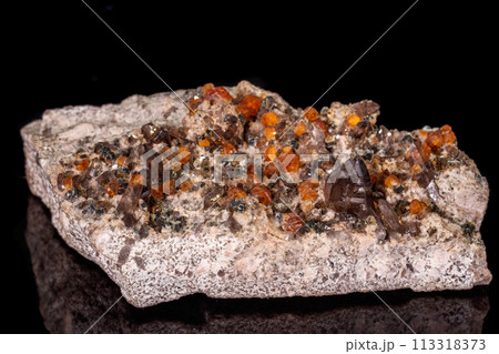 macro mineral stone Grossular, Garnet, Epidote on a black background macro mineral stone Grossular, Garnet, Epidote on a black background 113318373