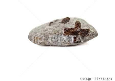 macro mineral stone Staurolite on a white background macro mineral stone Staurolite on a white background 113318383