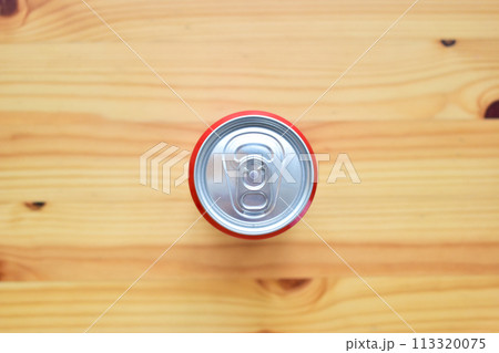 aluminium red cans of soft drink put on brown wooden table aluminium red cans of soft drink put on brown wooden table 113320075