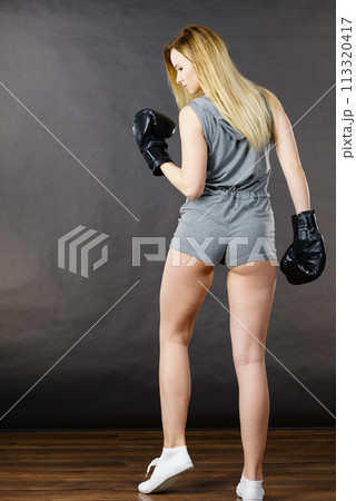 Boxer girl exercise with boxing gloves. 113320417