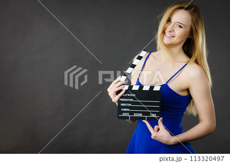 Woman holding professional film slate Woman holding professional film slate 113320497