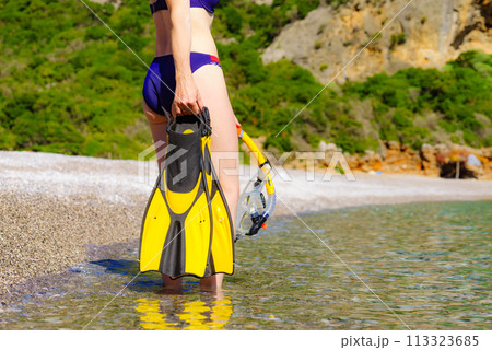 Woman with flippers snorkeling tube on beach Woman with flippers snorkeling tube on beach 113323685