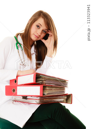 Paperwork. Overworked doctor woman with documents 113323941